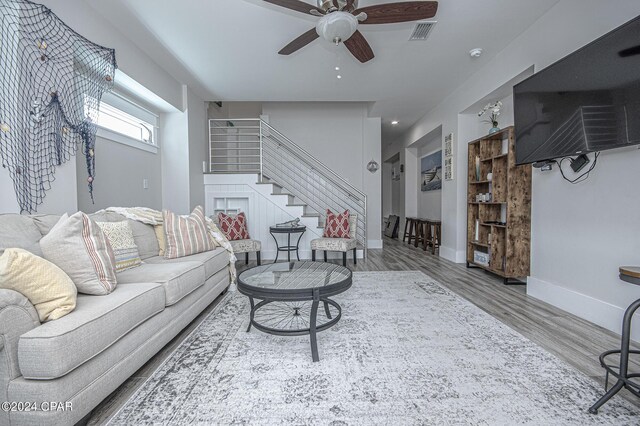 living room with ceiling fan and hardwood / wood-style floors