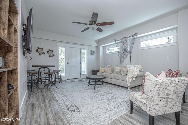 living room with wood-type flooring and ceiling fan