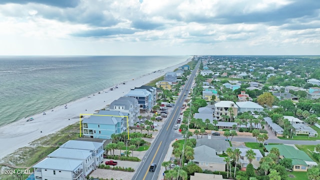 drone / aerial view featuring a water view and a beach view