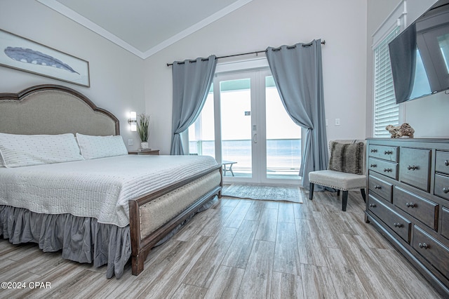 bedroom featuring light wood-type flooring, lofted ceiling, french doors, and crown molding