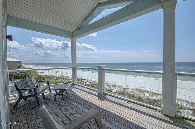 deck featuring a water view and a beach view