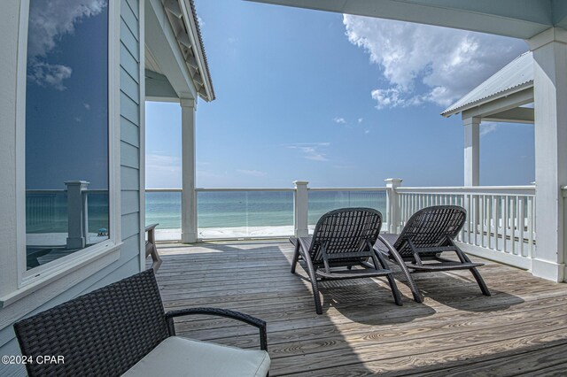 deck with a water view and a view of the beach