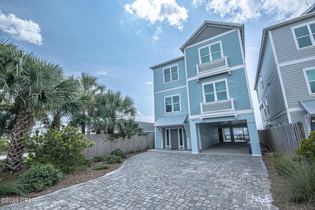 raised beach house with a carport and a balcony