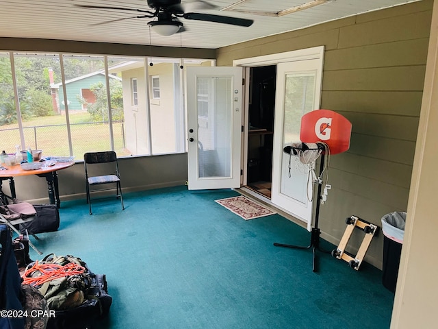 sunroom featuring ceiling fan