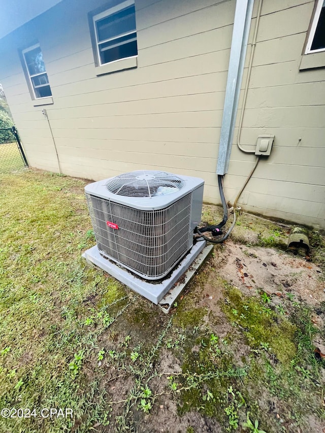 exterior details featuring wood walls and central air condition unit