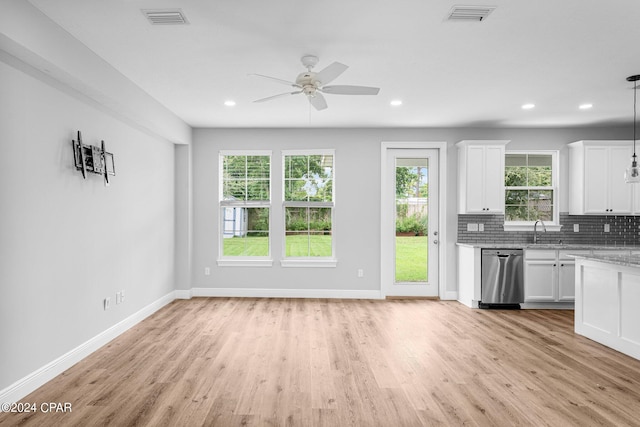 kitchen with light hardwood / wood-style floors, white cabinets, decorative light fixtures, ceiling fan, and stainless steel dishwasher