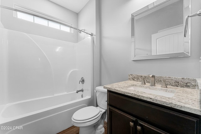 full bathroom with hardwood / wood-style floors, vanity, bathing tub / shower combination, and toilet