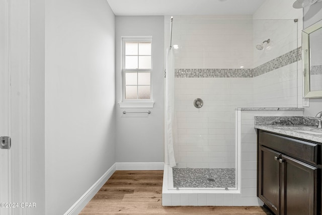 bathroom with a shower with shower curtain, wood-type flooring, and vanity