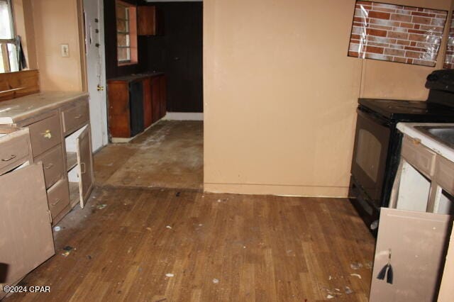 kitchen with black range with electric cooktop and dark wood-type flooring