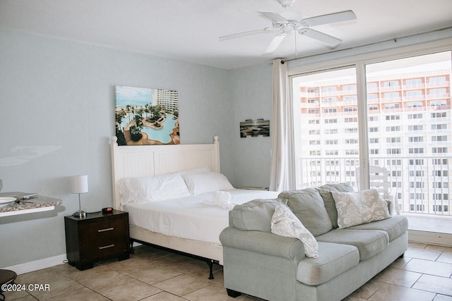 tiled bedroom with multiple windows and ceiling fan