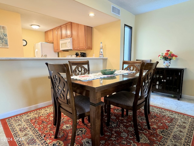 dining space with light tile patterned floors