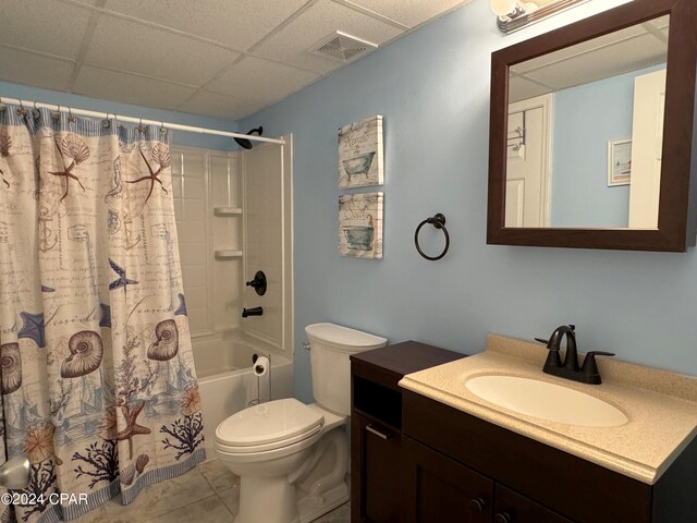 hallway with tile patterned flooring and a paneled ceiling