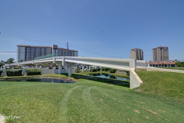 view of property's community featuring a water view and a yard