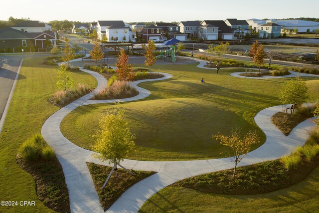 view of home's community with a yard