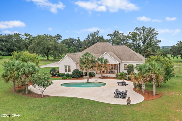 view of swimming pool featuring a lawn and a patio