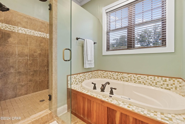 bathroom with tile patterned flooring and shower with separate bathtub