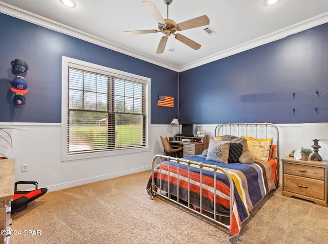 carpeted bedroom featuring crown molding and ceiling fan