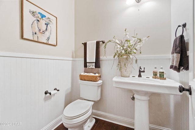 bathroom featuring wood-type flooring and toilet