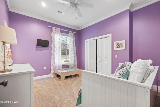 bedroom featuring carpet flooring, a closet, ceiling fan, and crown molding