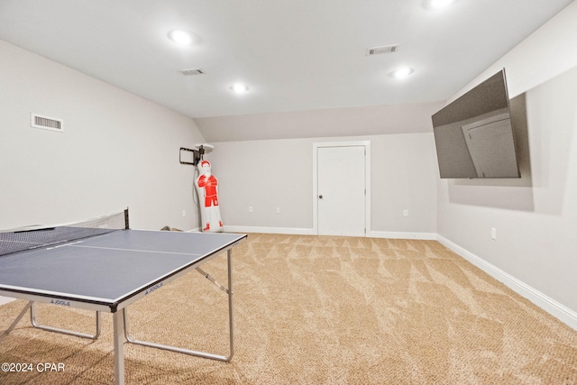 rec room with vaulted ceiling and carpet flooring