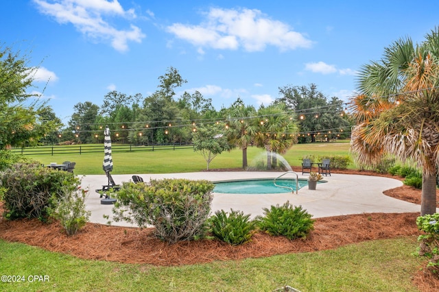 view of swimming pool featuring a yard and a patio area