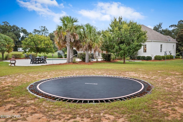 view of yard featuring a trampoline and a patio area