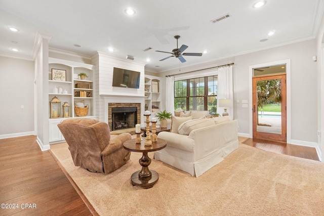 living room featuring crown molding, ceiling fan, and light hardwood / wood-style floors