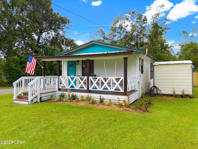 view of front of house featuring covered porch and a front yard