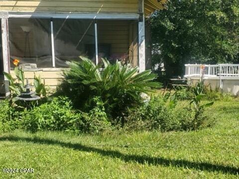 view of side of home featuring a lawn