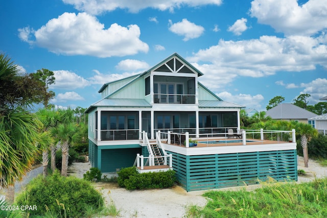 exterior space featuring a sunroom and a deck