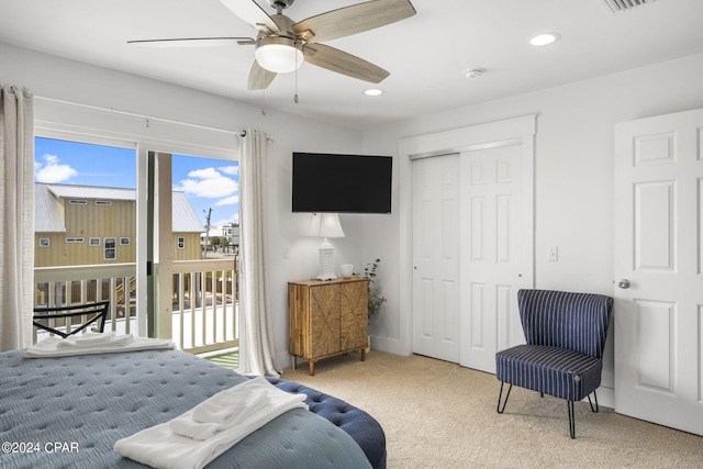 carpeted bedroom featuring access to exterior, ceiling fan, and a closet