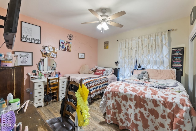 bedroom with ceiling fan and light hardwood / wood-style flooring