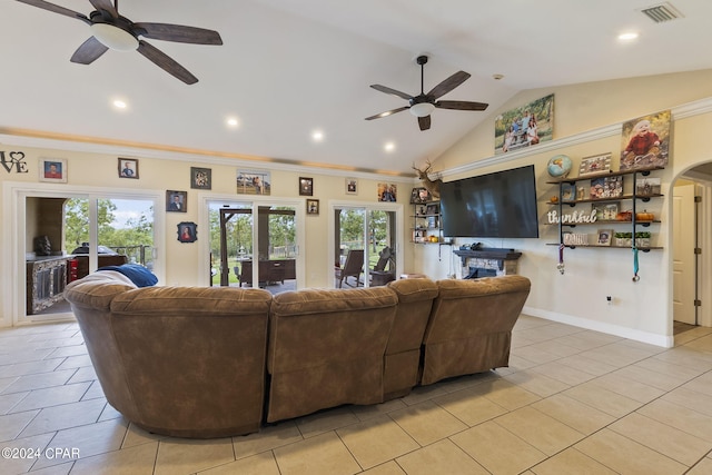 living room with lofted ceiling, light tile patterned floors, ornamental molding, ceiling fan, and french doors