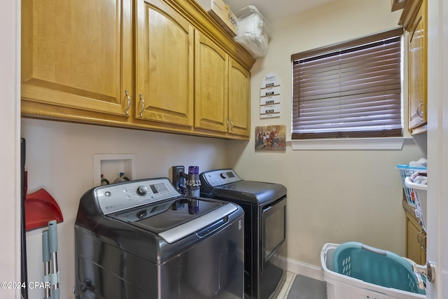 laundry room with cabinets and washing machine and dryer