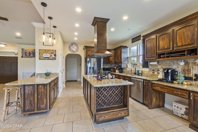 kitchen featuring island exhaust hood, appliances with stainless steel finishes, backsplash, and a center island