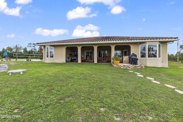 mediterranean / spanish home with a front lawn and a patio