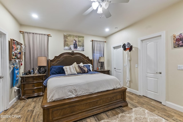 bedroom with wood-type flooring and ceiling fan