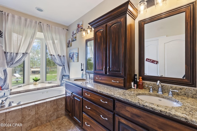 bathroom with vanity, tiled bath, and tile patterned flooring