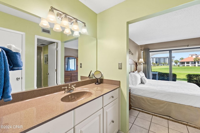 bathroom with vanity, a textured ceiling, and tile patterned flooring