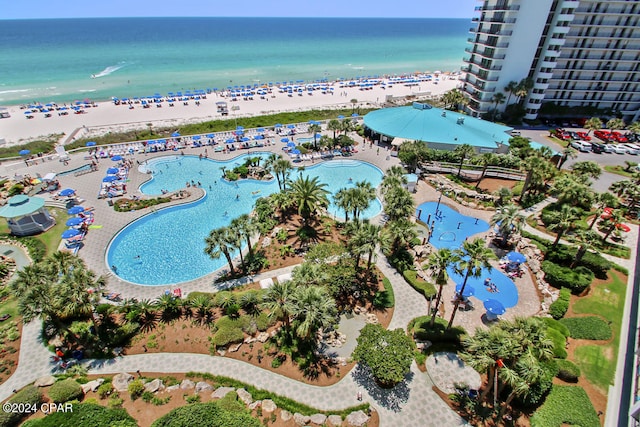 bird's eye view featuring a water view and a beach view