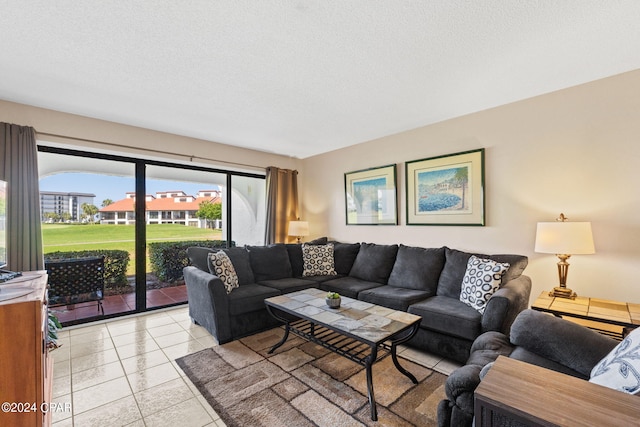 tiled living room featuring a textured ceiling