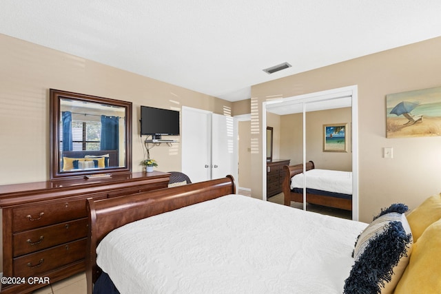 bedroom featuring light tile patterned flooring and a closet