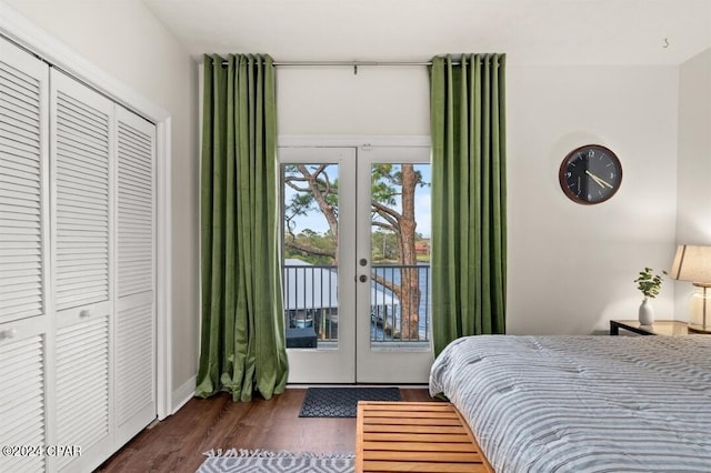 bedroom featuring dark hardwood / wood-style floors, a closet, access to outside, and french doors