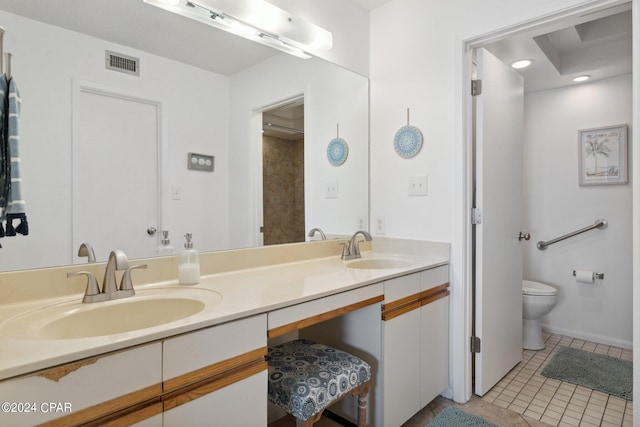 bathroom with tile patterned flooring, vanity, and toilet