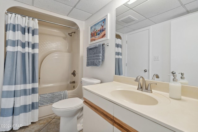 full bathroom featuring tile patterned floors, a drop ceiling, vanity, and shower / tub combo