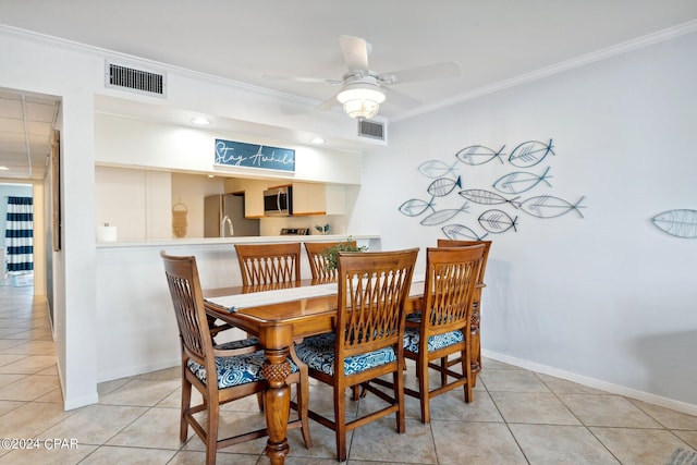 dining area featuring ceiling fan, ornamental molding, and light tile patterned flooring