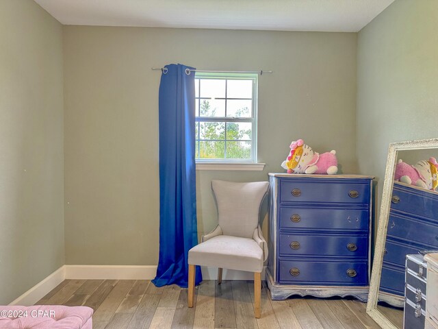 empty room featuring hardwood / wood-style floors and crown molding