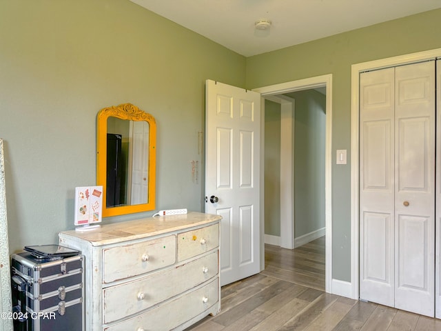 bedroom with a closet and light hardwood / wood-style floors