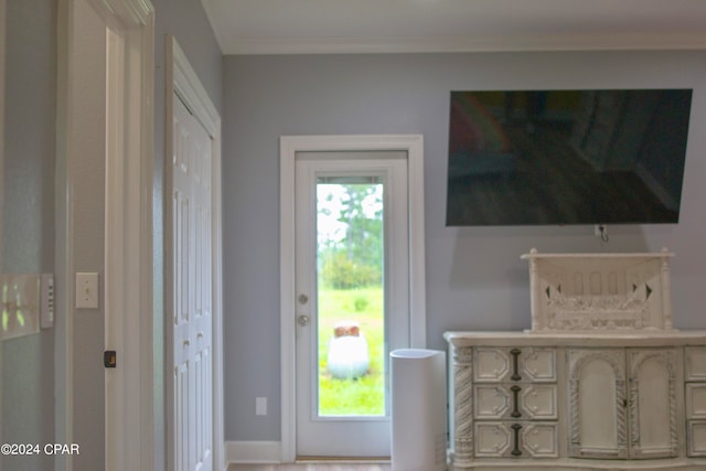 doorway to outside featuring ornamental molding