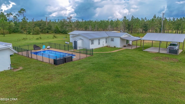 back of property with an outdoor structure, a yard, and a patio